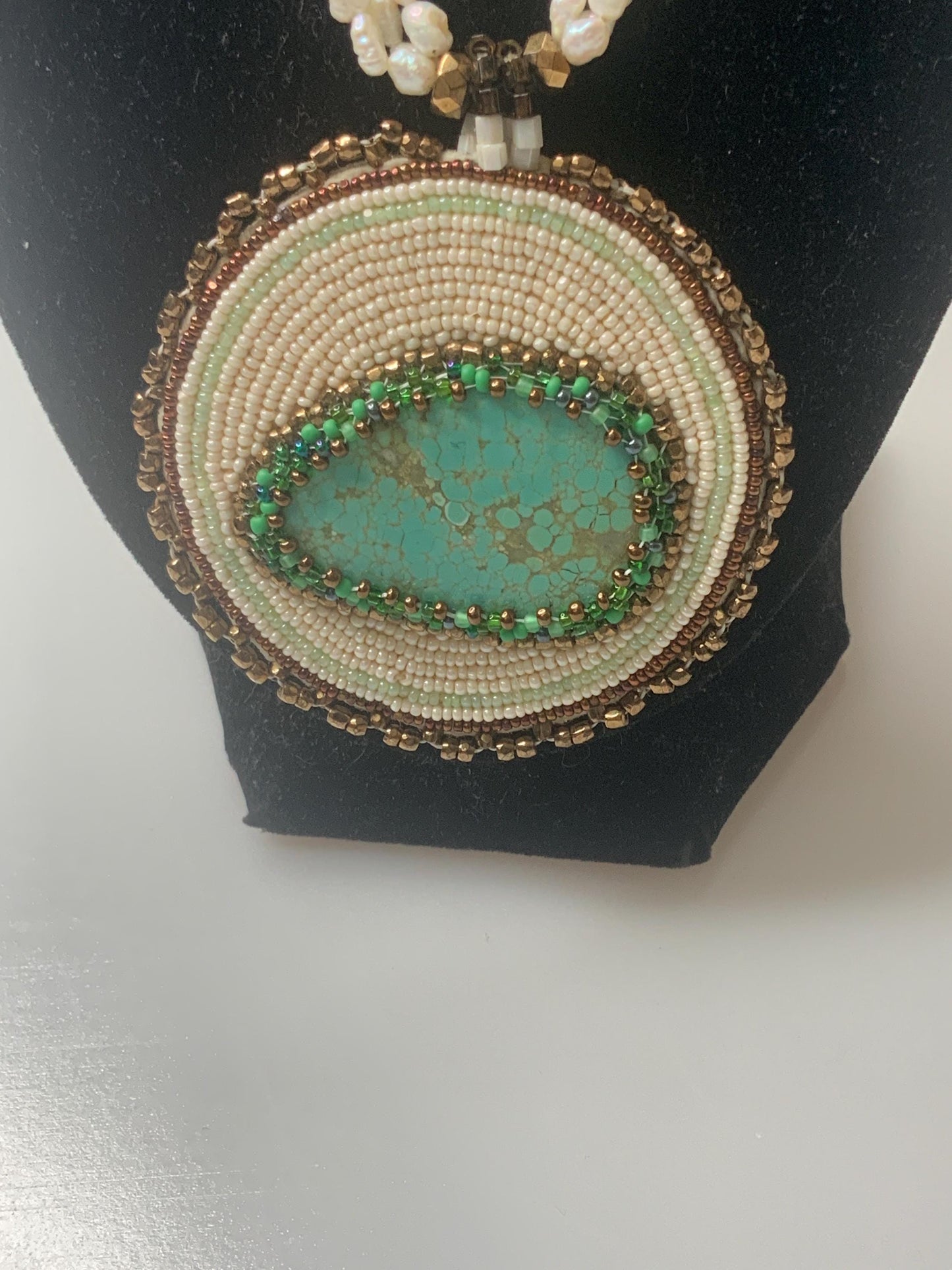 T.G. 2007 signed Turqoise beaded pendant on leather with three stands of pearls and other material beads with a open box 14k gold clasp.