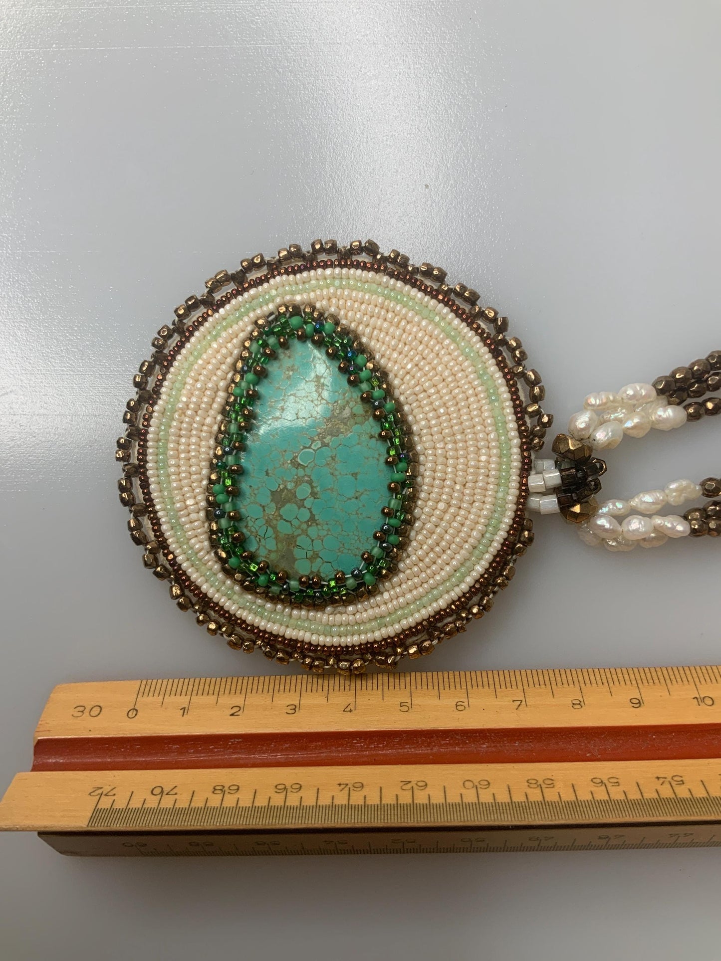 T.G. 2007 signed Turqoise beaded pendant on leather with three stands of pearls and other material beads with a open box 14k gold clasp.